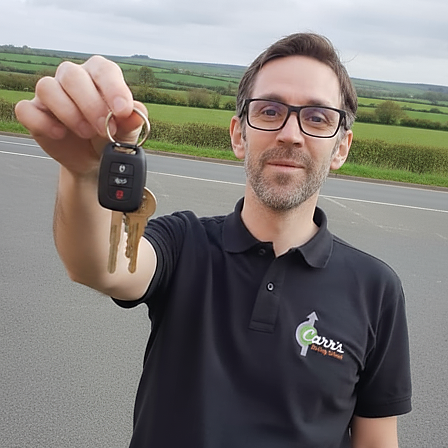 Phil holding out a set of car keys